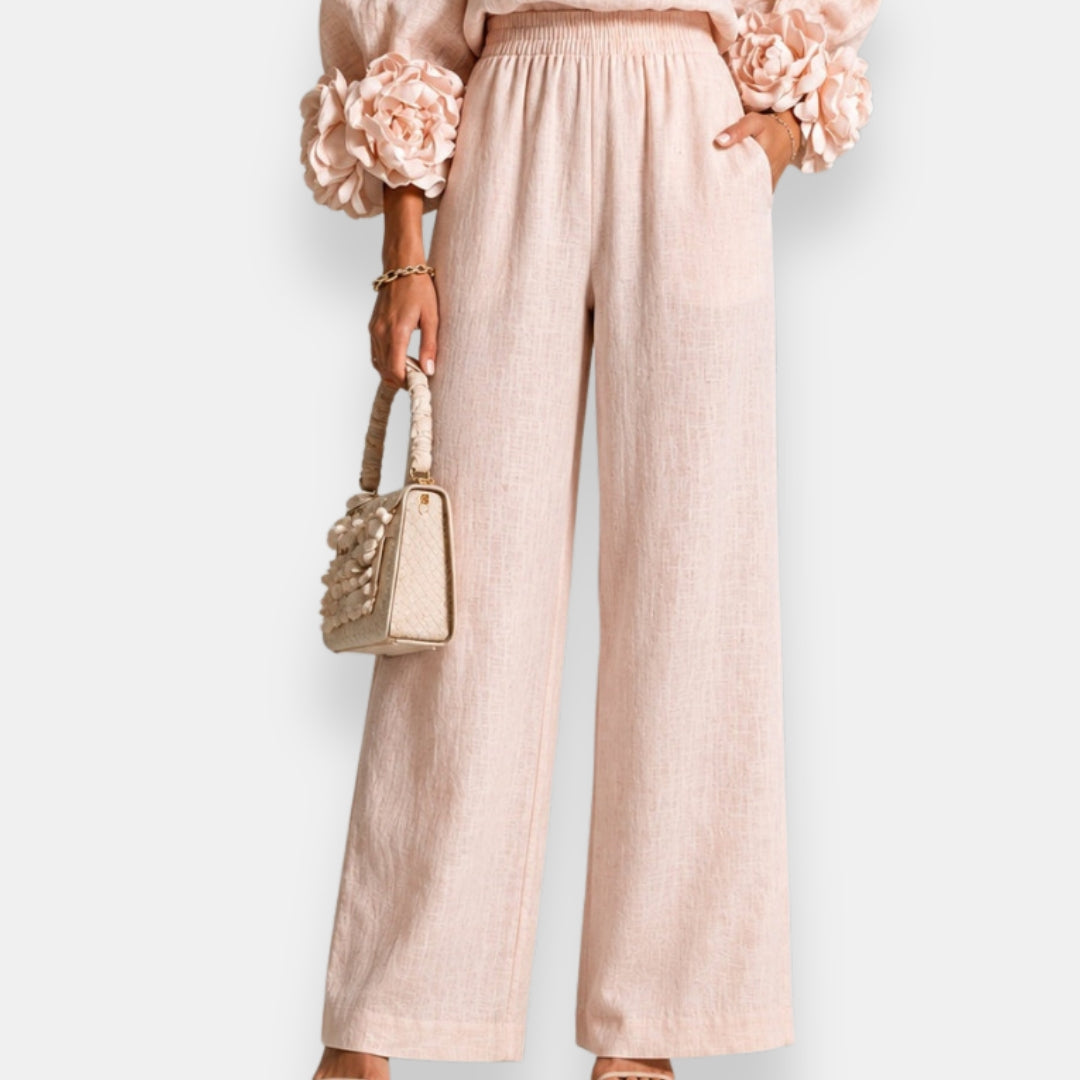 Close-up detail of the comfortable elasticated waistband on black wide-leg trousers, emphasizing ease of wear.