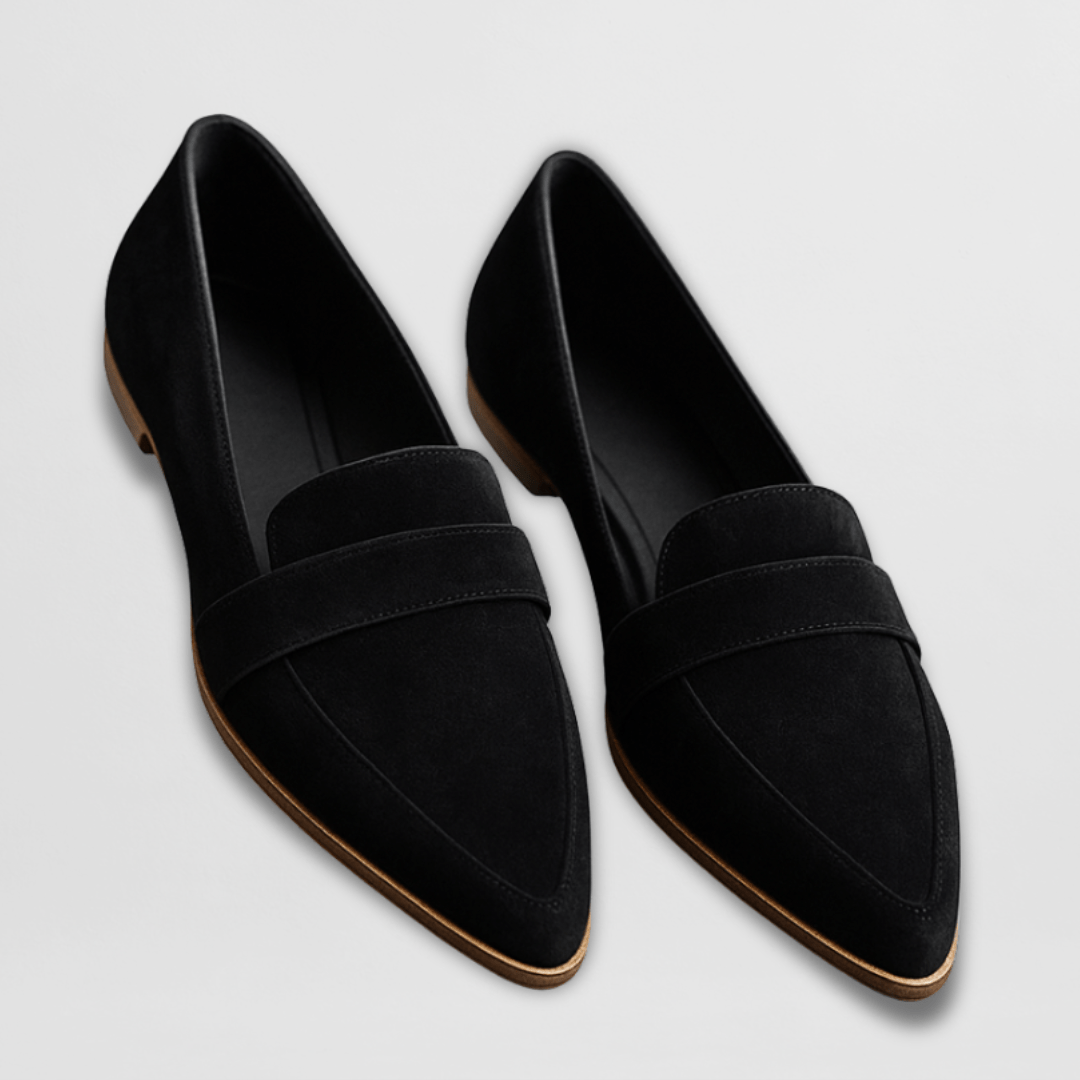 Overhead shot of a pair of grey suede loafers, highlighting the comfortable, smooth leather-look interior.