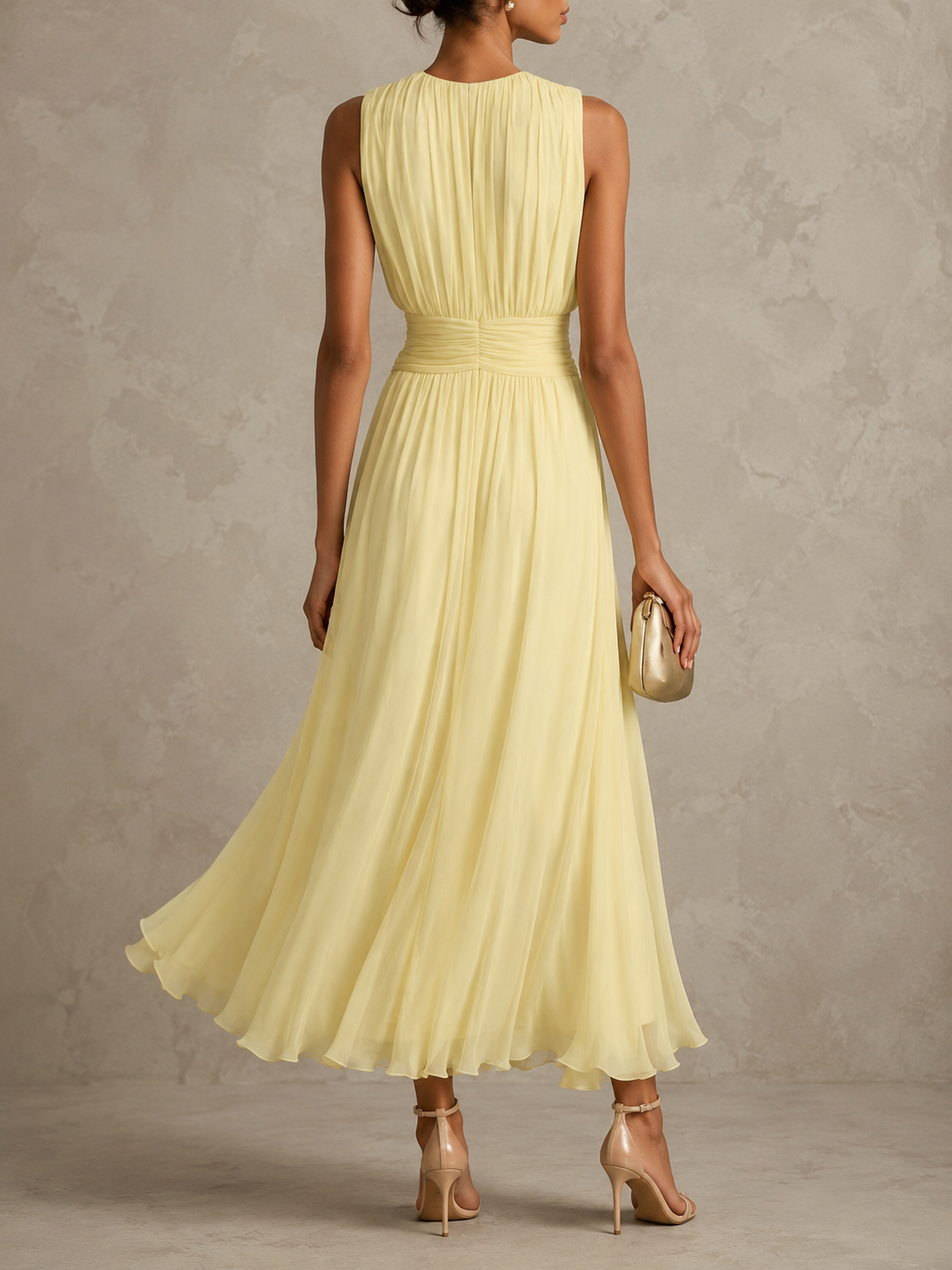 Side profile of a woman wearing the sleeveless maxi dress, demonstrating the flattering fit and graceful drape of the skirt.