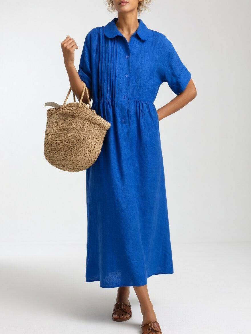 Close-up of the light blue cotton shirt dress fabric, showcasing the breathable texture and quality material.