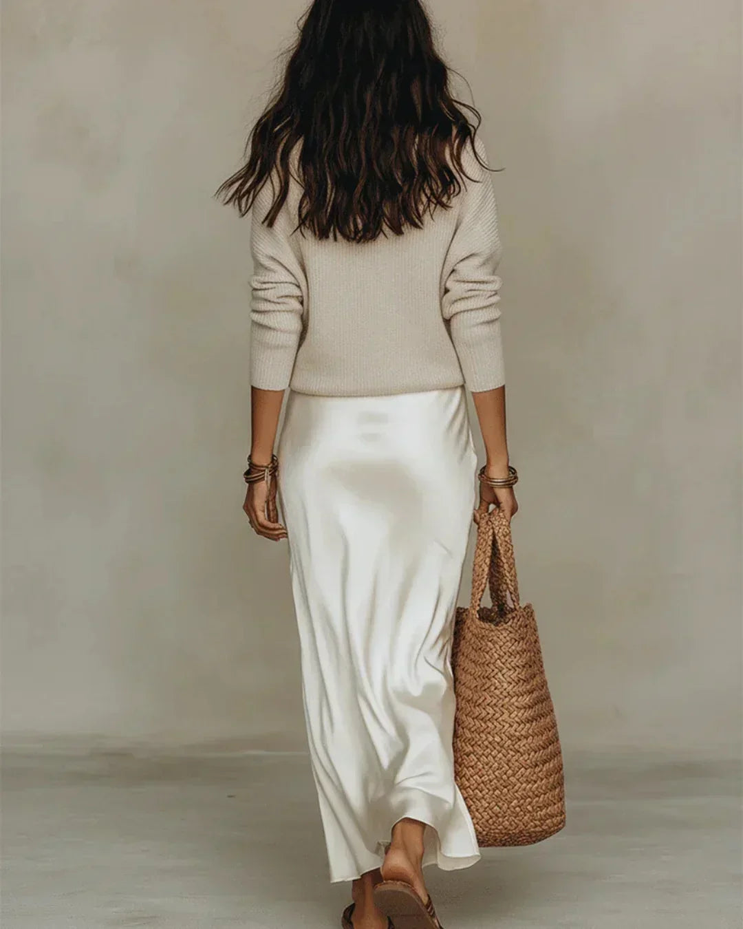 Side profile of the cream ribbed knit sweater, showing its relaxed fit and comfortable drape.