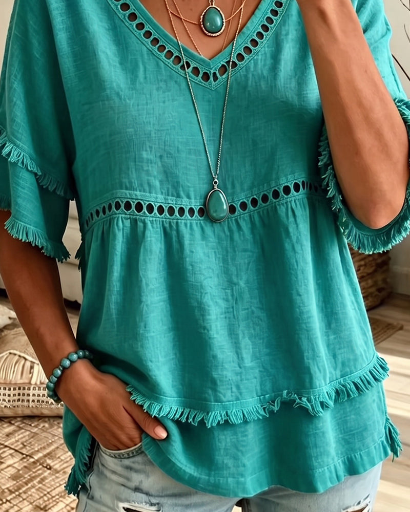 Flat lay of the entire collection of V-neck blouses in various colors, ready for effortless styling.