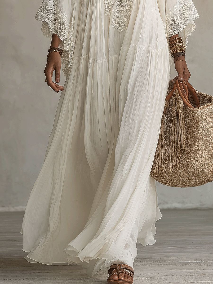Model walking on a beach at sunset, elegantly styled in the versatile Ianthe lace V-neck maxi dress.