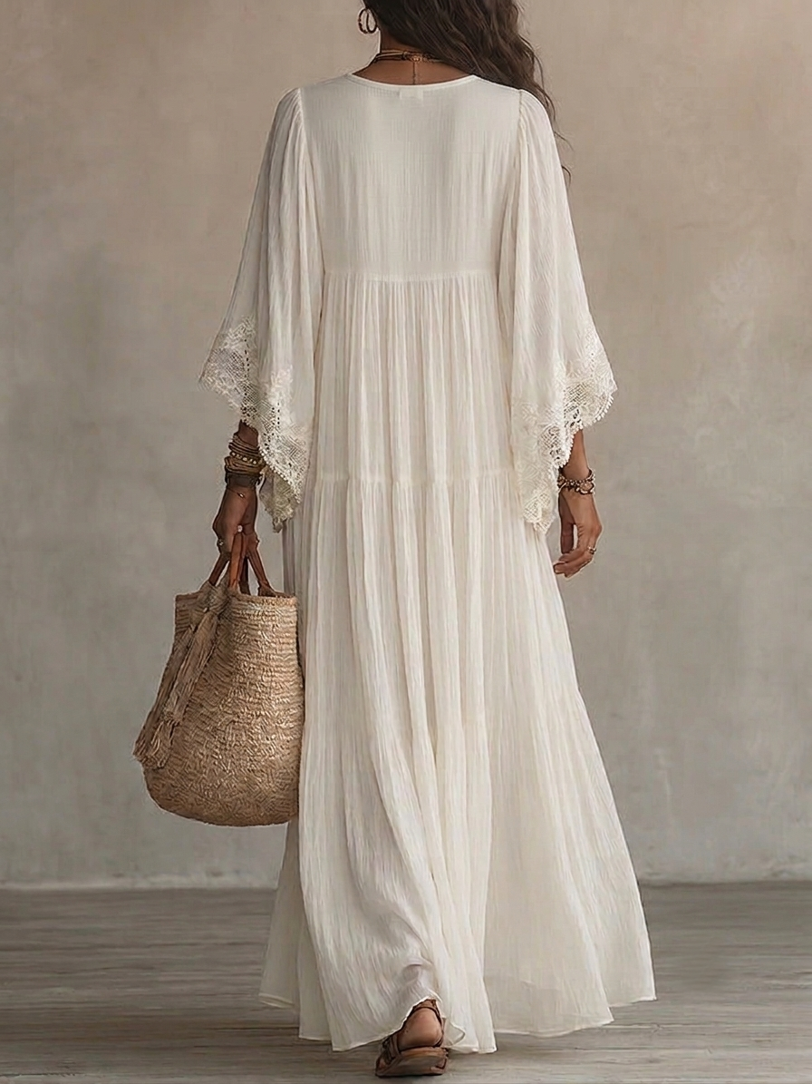 Close-up of the delicate white lace V-neckline and wide bat sleeves on the Ianthe ivory maxi dress.
