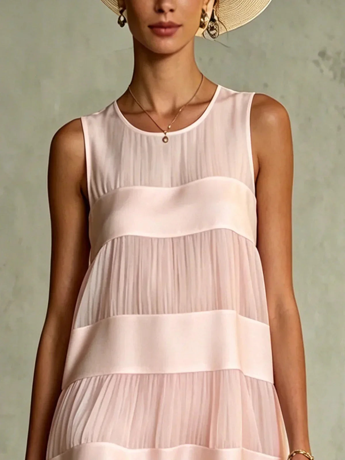 Full front view of the light pink layered mini dress, showcasing its flattering A-line cut and gathered ruffled hem.