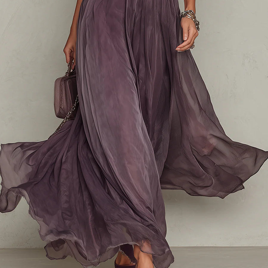 Lifestyle shot of the purple chiffon lace maxi dress in a garden setting, emphasizing its suitability for outdoor events.