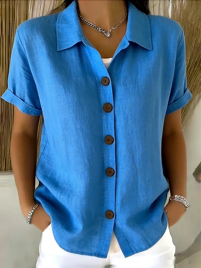 Side profile of the women's short-sleeve button-up shirt in blue, showcasing its relaxed fit.