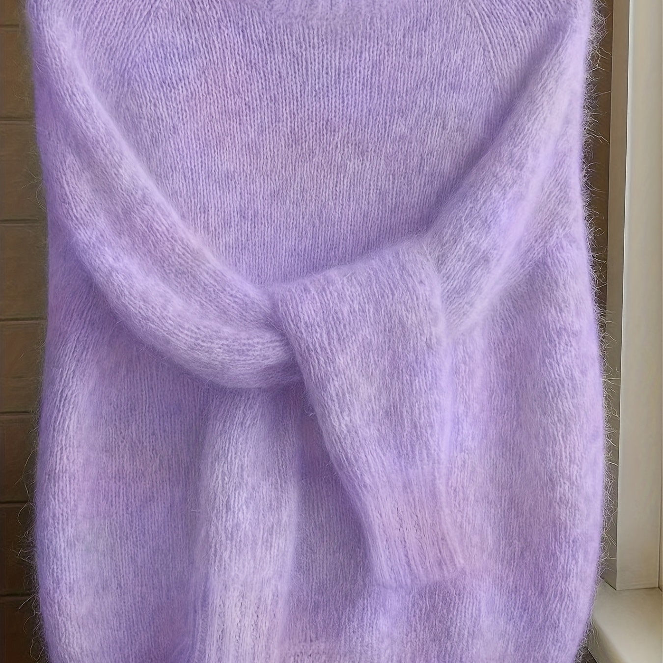 Close-up of the luxurious cashmere-blend knit texture on the Elara sweater, highlighting its fine quality.