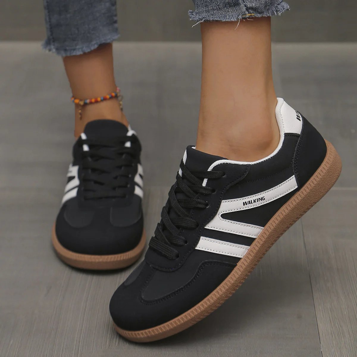 Close-up of the breathable mesh upper and lacing system of the off-white Elara orthopaedic cushioned trainers.