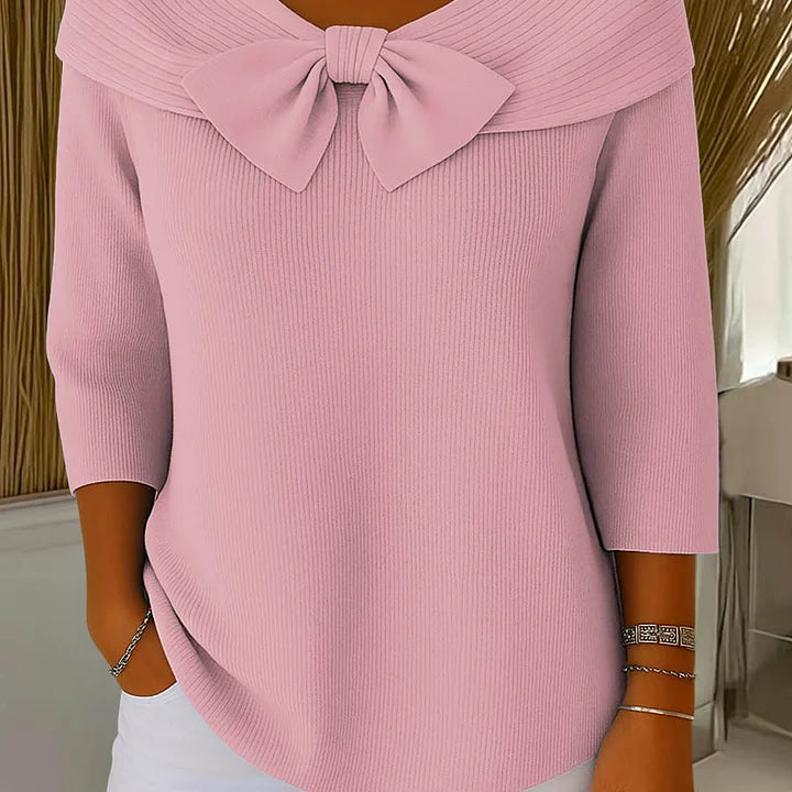 Side profile of a model wearing the Elara elegant knitted top in pink, highlighting the comfortable regular fit and sleeve length.