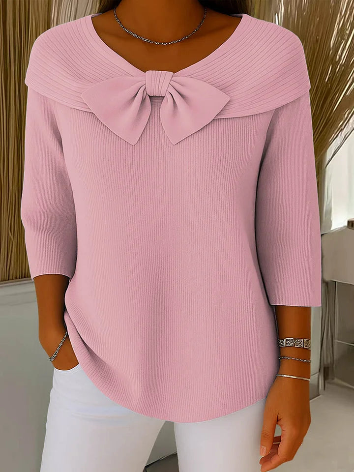 Side profile of a model wearing the Elara elegant knitted top in pink, highlighting the comfortable regular fit and sleeve length.