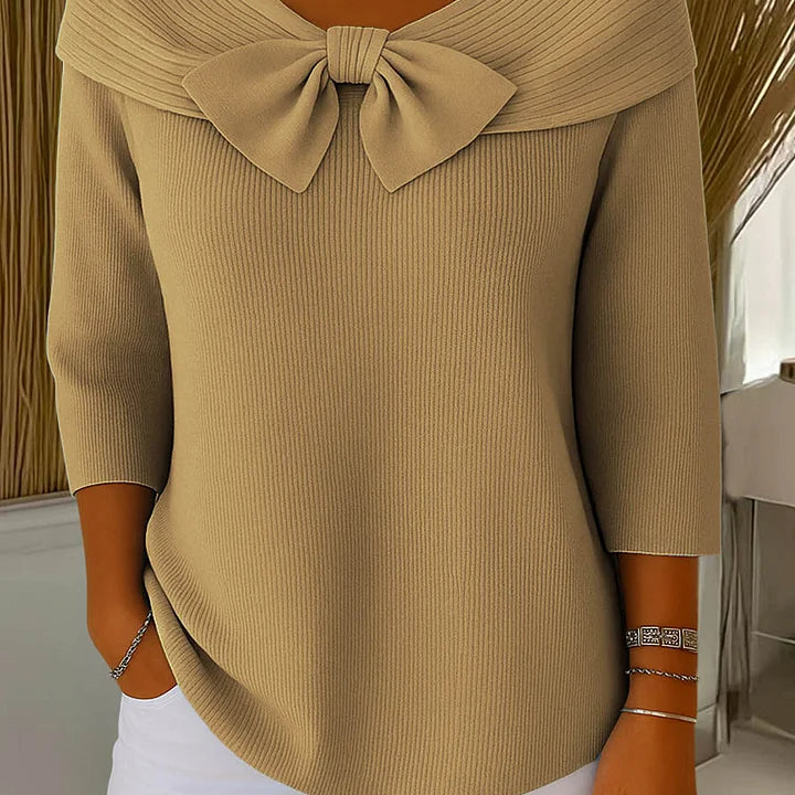 Close-up detail of the sophisticated bow on the Elara elegant knitted top, emphasizing its refined craftsmanship.