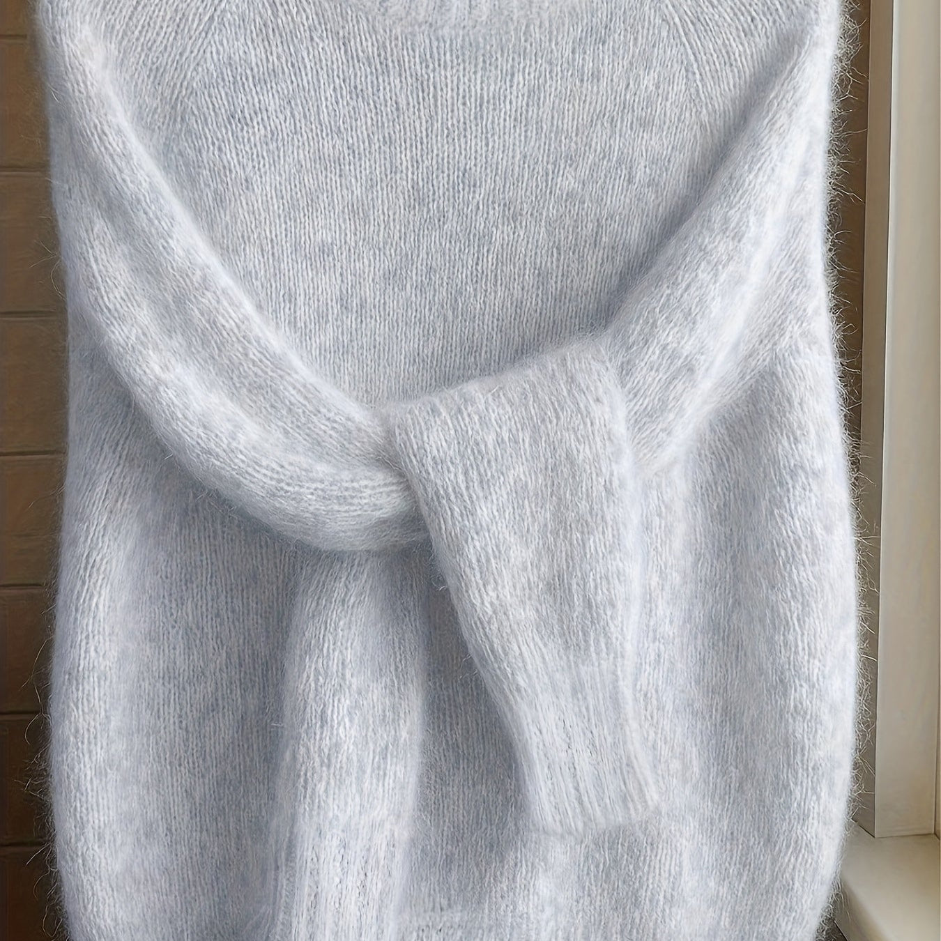 Model wearing the Elara cashmere-blend sweater in purple, styled casually with jeans, full body shot.