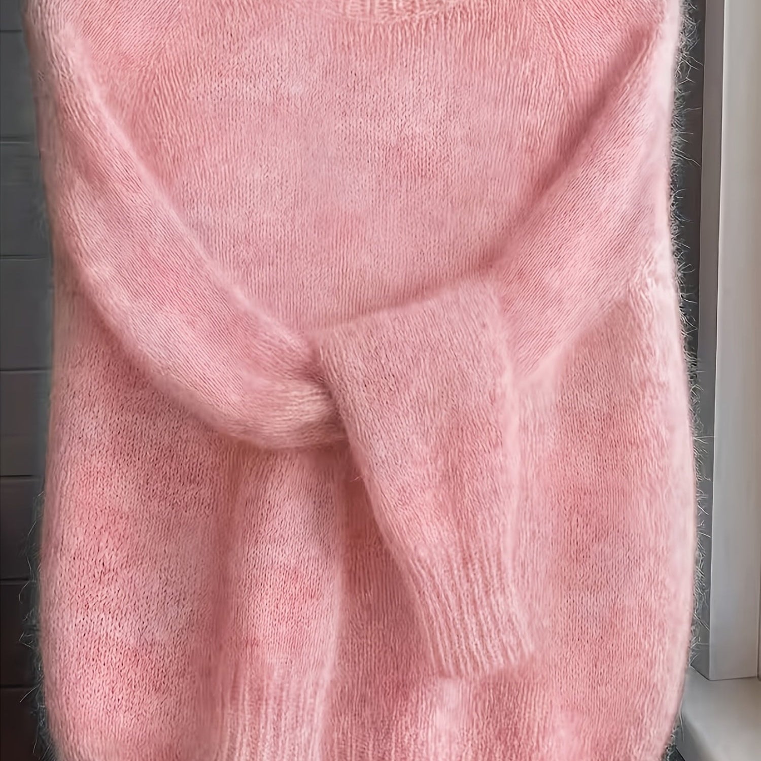 Side profile of the Elara cashmere-blend sweater in light grey, demonstrating its elegant drape and silhouette.