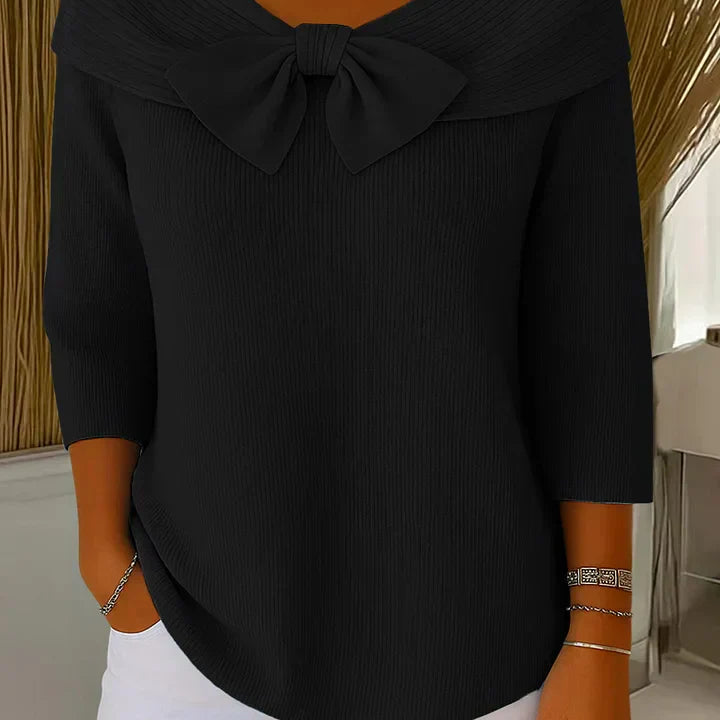 Back view of the Elara elegant knitted top in black, illustrating the smooth knit and overall silhouette.