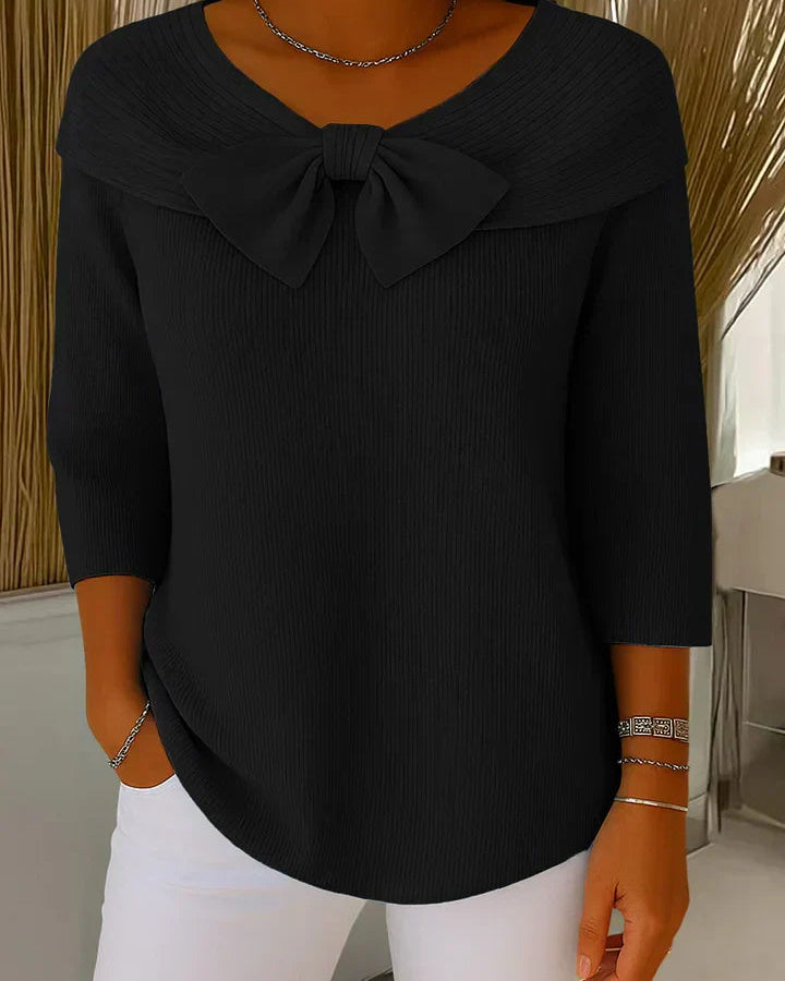 Back view of the Elara elegant knitted top in black, illustrating the smooth knit and overall silhouette.