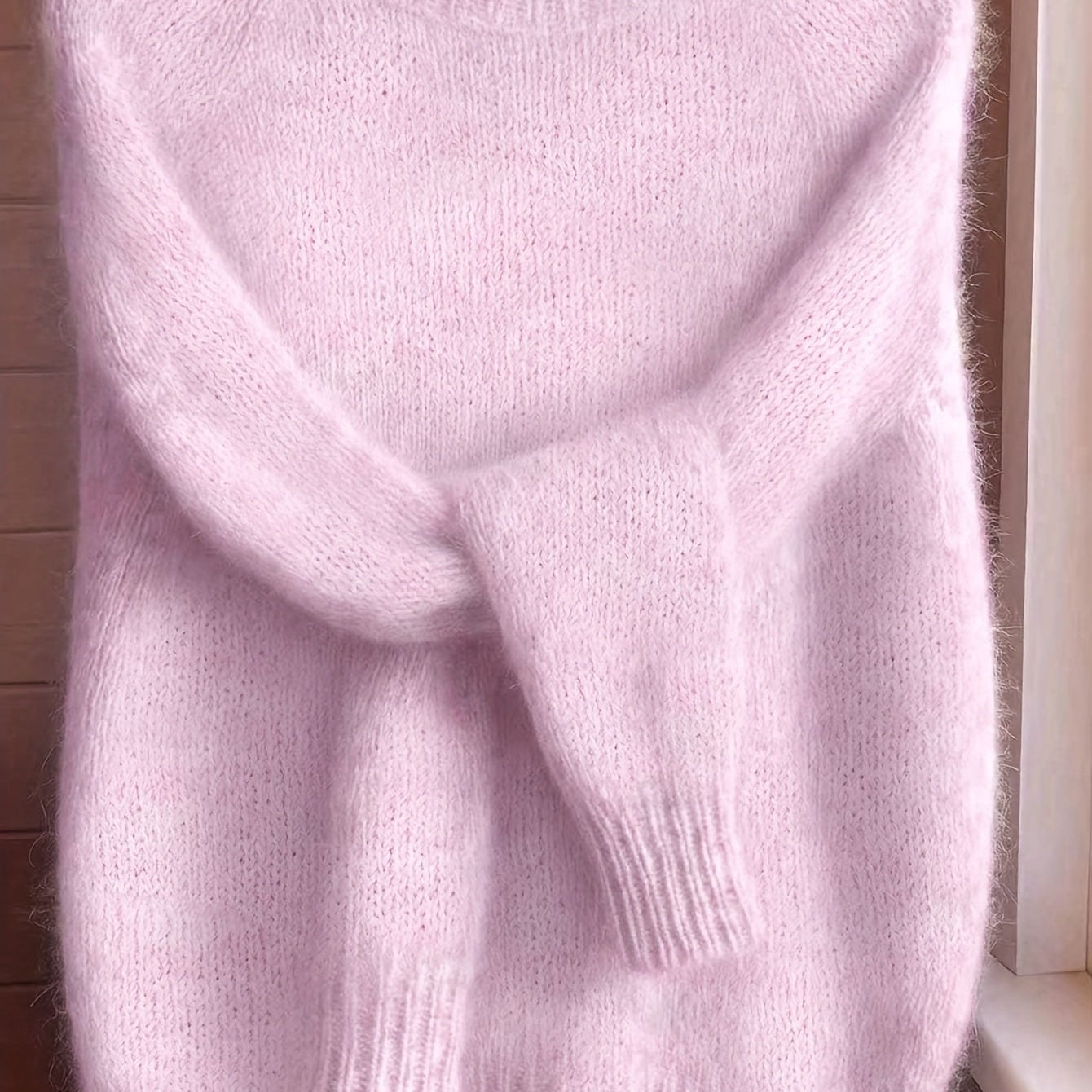 Back view of the Elara cashmere-blend sweater in soft pink, showing the smooth, even knit from behind.