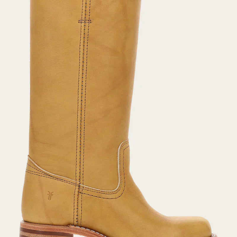 Elara classic Western boots in a vibrant yellow, styled casually with denim jeans, capturing a dynamic lifestyle shot.