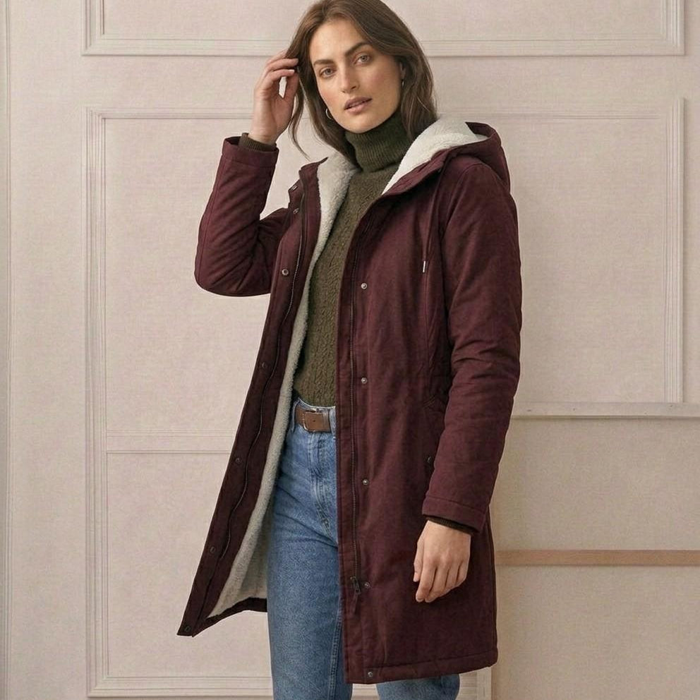 View of the Elara parka's full-length zipper with the button-down storm flap for complete wind protection.