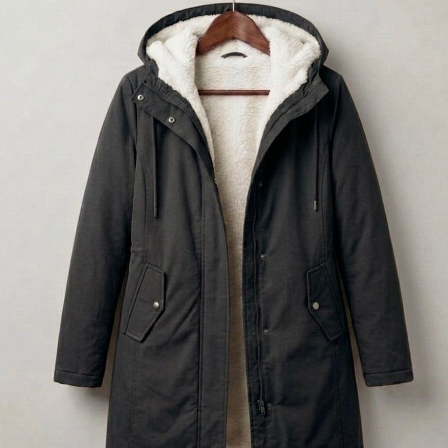 Detailed image of the deep, fixed storm hood on the Elara parka, designed for maximum face protection.