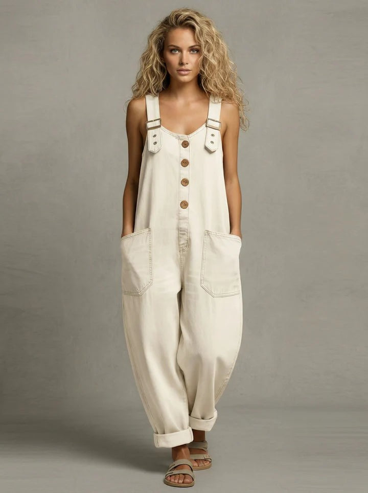 Full-length shot of the black utility jumpsuit, showing its modern dungaree-inspired style.