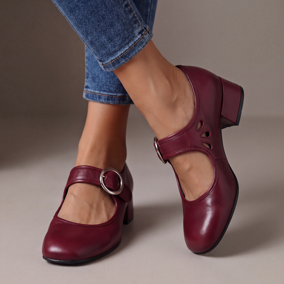 Close-up of the rounded toe box and side cut-outs on a burgundy orthopaedic Mary Jane shoe, highlighting comfort features.