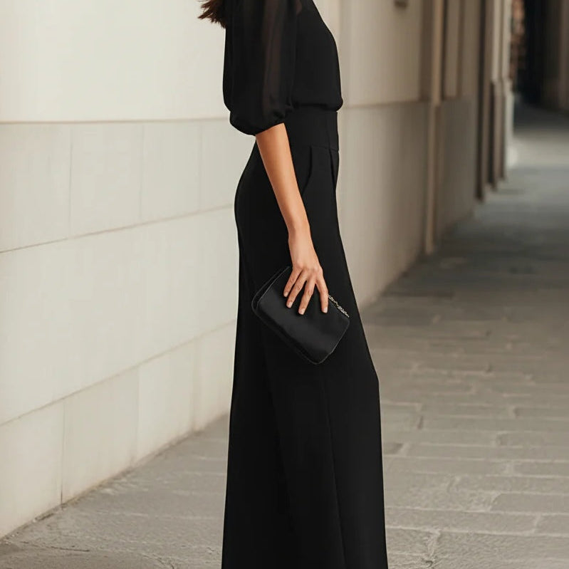 Side profile of a model wearing the Indira elegant three-piece set, emphasizing the flowing silhouette of the wide-leg pants.