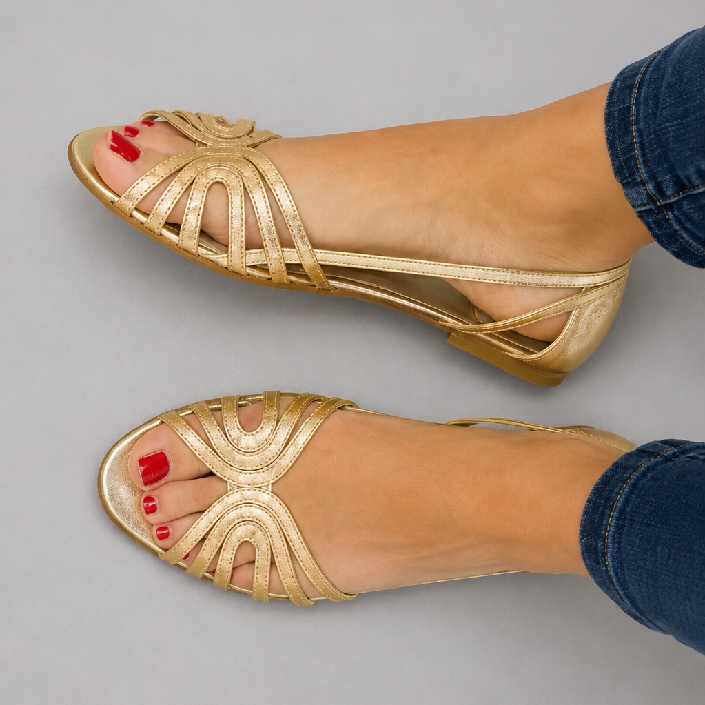 Pair of Kaelen vintage sandals in gold color, showcasing the elegant golden strap detail from a top-down view.