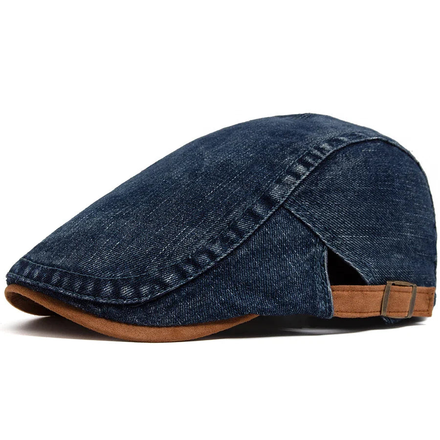 Close-up detail of the Kian classic denim flat cap fabric, showing the fine denim weave and stitching.