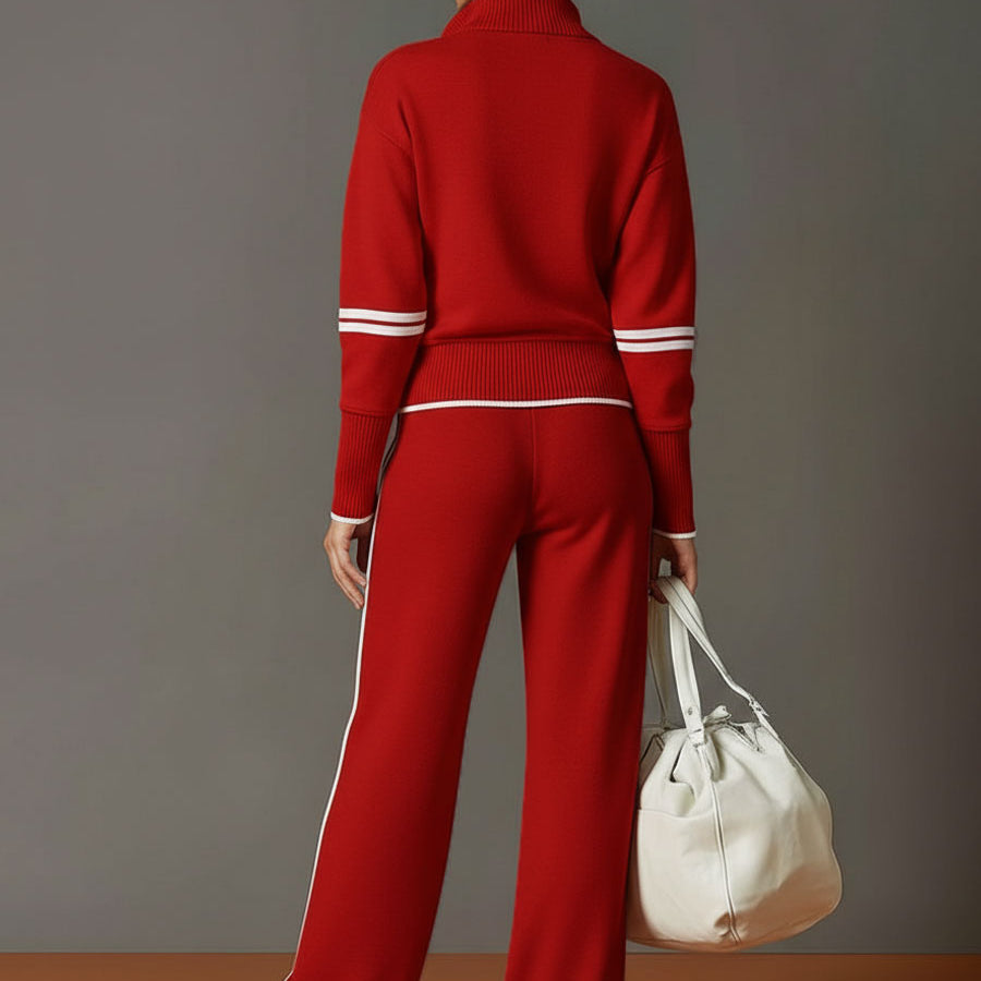 Woman casually leaning against a wall, showcasing the relaxed yet polished look of the wide-leg pants.