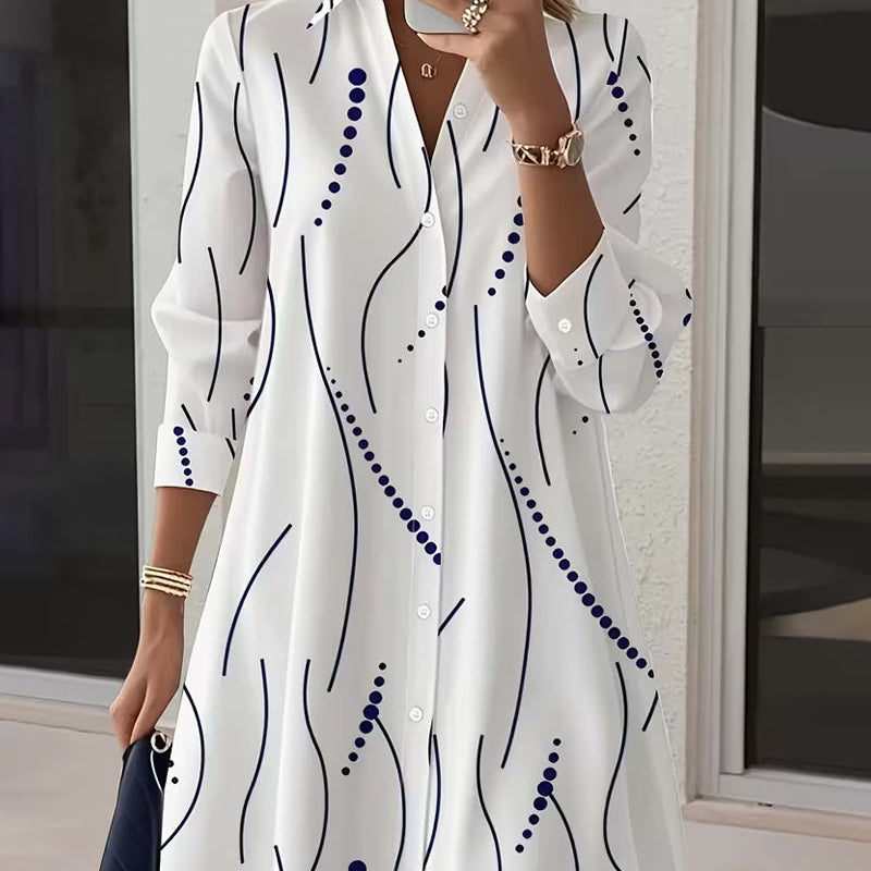 Side profile of a woman wearing the Kora dress, highlighting the flow of the wavy stripe fabric and long sleeves.