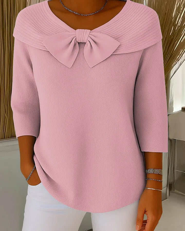 Side profile of the Lana elegant knit tunic, highlighting the natural drape of the fabric and moderate sleeve length.
