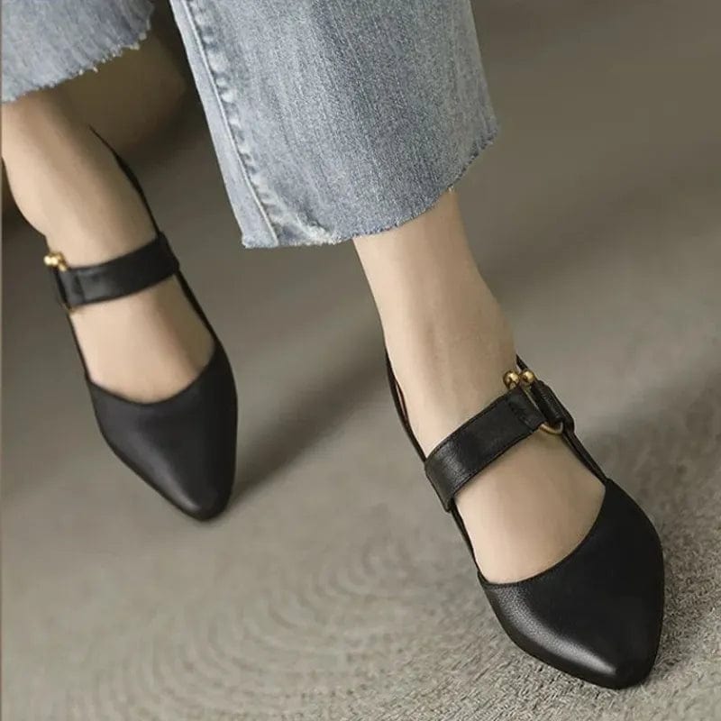 Side profile of brown leather slingback heels, highlighting the adjustable strap and gleaming gold-tone buckle.