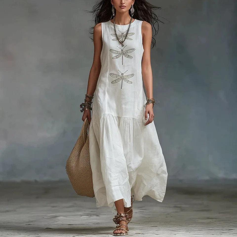 Woman wearing a light blue bohemian midi dress, showcasing its loose fit and elegant drape.