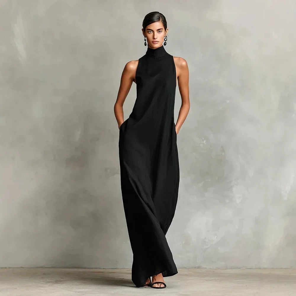 Rear view of a burgundy sleeveless maxi dress, displaying the long, graceful drape of the fabric.