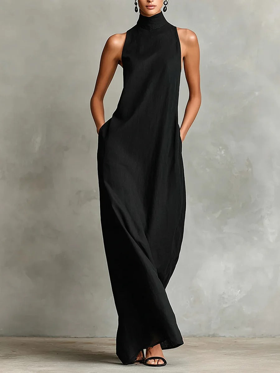 Side profile of a woman wearing a pink sleeveless maxi dress, highlighting the relaxed fit and discreet side pockets.
