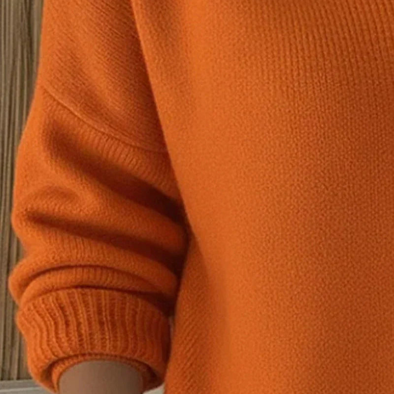 Marlow everyday cardigan in a bright orange, showcasing the smooth knit and simple sleeve finishes.