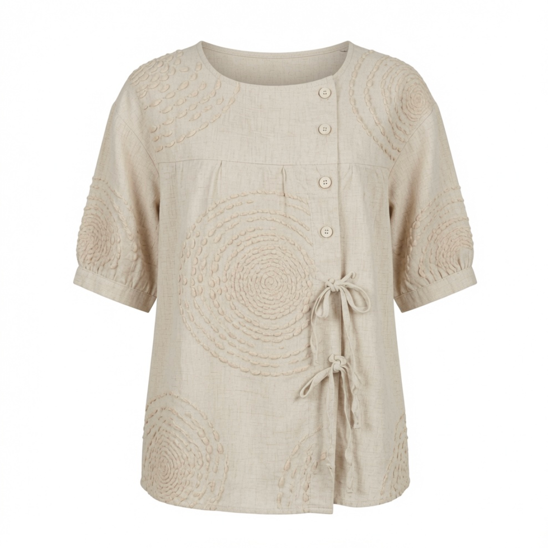 Close-up detail of the raised circular embroidery on the Mirabelle casual top's fabric surface.