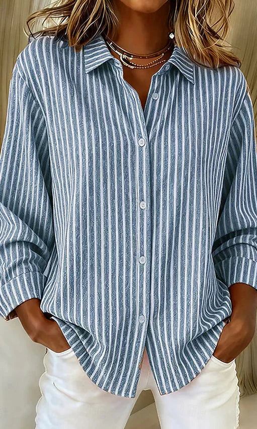 Front view of a blue Nina relaxed fit shirt with vertical stripes, showcasing its loose drape.