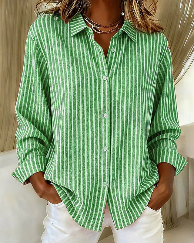 Side profile of a woman wearing the blue Nina relaxed fit shirt, highlighting the long sleeves.