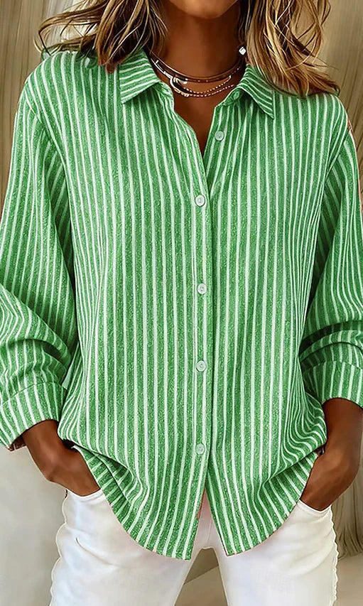 Side profile of a woman wearing the blue Nina relaxed fit shirt, highlighting the long sleeves.