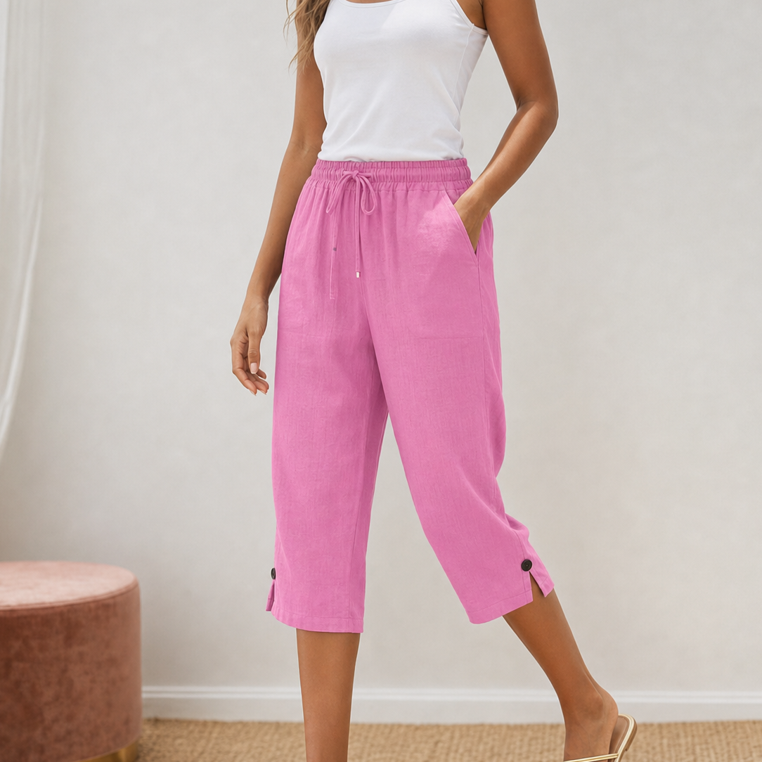 Detailed view of the stylish button-slit hem on the lower leg of the capri trousers.