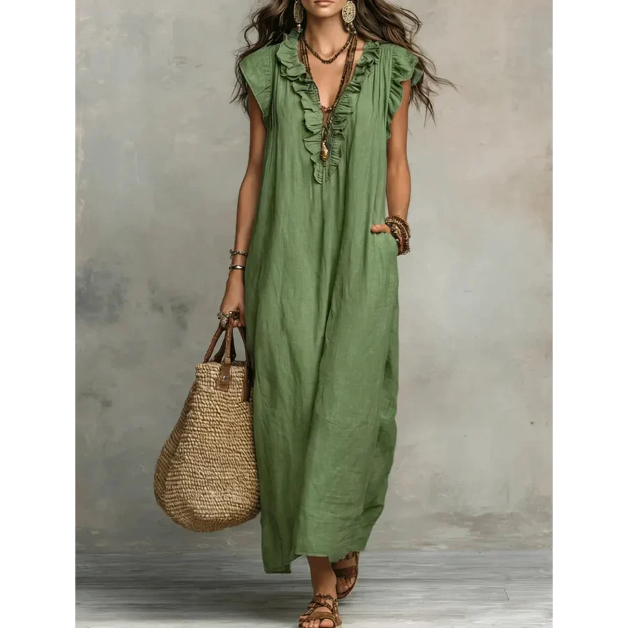 Side profile of the elegant long dress, highlighting the graceful movement of the natural fabric.