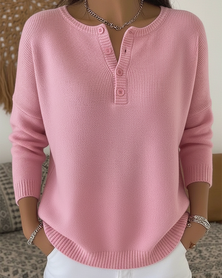 Close-up detail of the button-up closure on the Romy comfort pants, showcasing the subtle elegance.