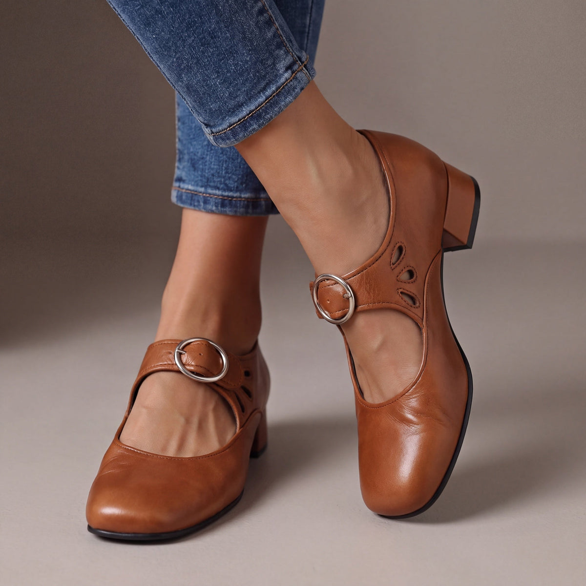 Lifestyle shot of a woman wearing tan orthopaedic Mary Jane shoes, walking comfortably on a city street.