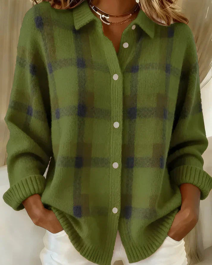 Close-up detail of the button closure on the orange Sable relaxed fit cardigan.