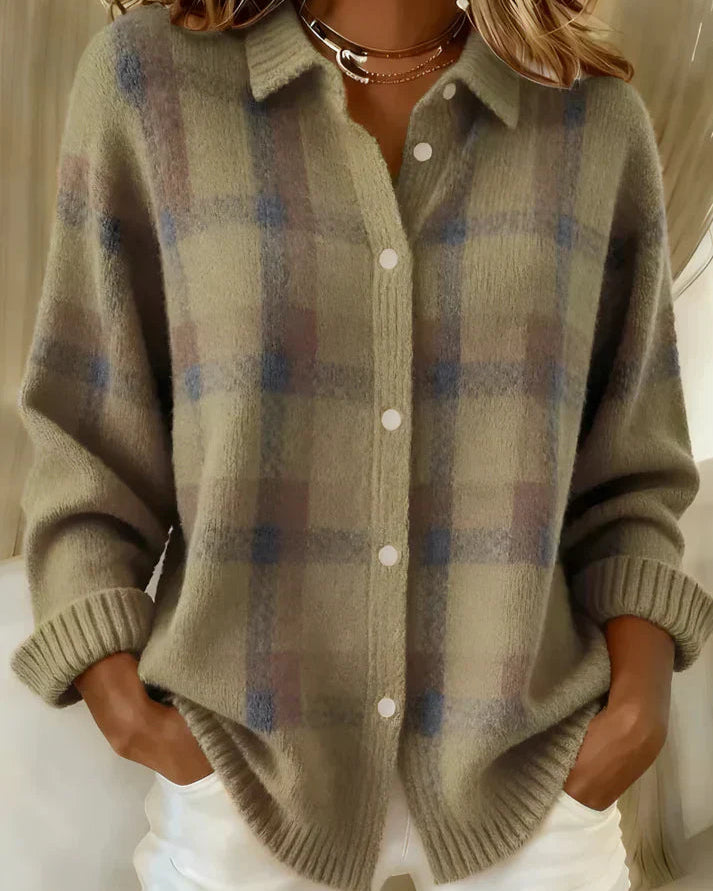 Woman comfortably seated, wearing the orange Sable relaxed fit cardigan, illustrating its comfort.