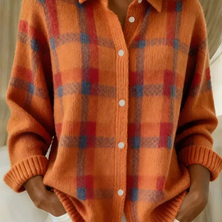 A stack of Sable relaxed fit cardigans in various colors, neatly folded.