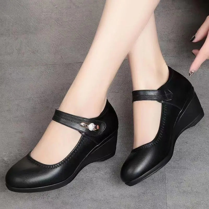 A woman's feet in red Elara mid-heel shoes, standing gracefully, showcasing good posture and elegant appeal.