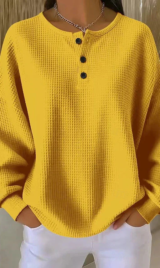 Overhead view of yellow Serena shorts, folded neatly to display the practical design and texture.